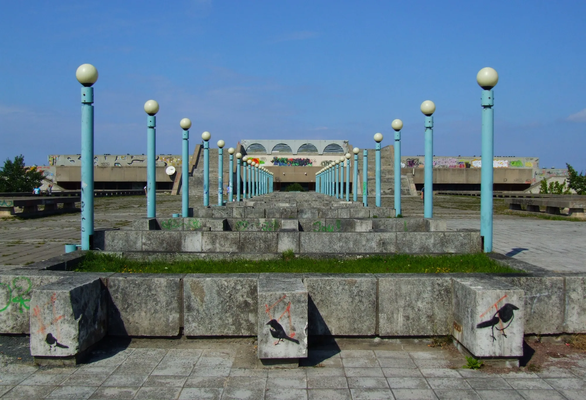 The brutalist Soviet-era Linnahall concert hall in Tallinn, with tiered concrete terraces and broad steps leading toward the sea