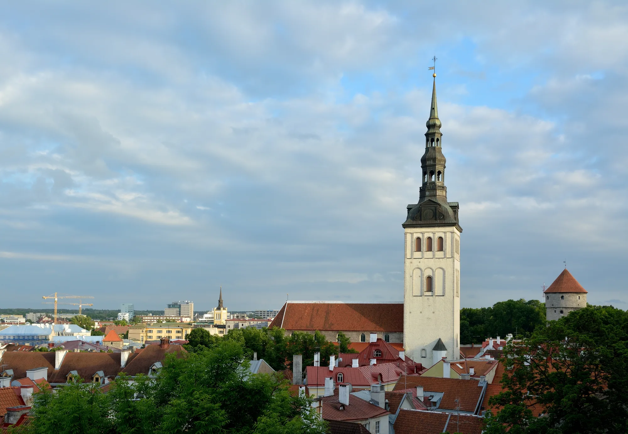 St Nicholas' Church (Niguliste kirik) in Tallinn, its tall white tower and dark green octagonal spire above the Old Town rooftops