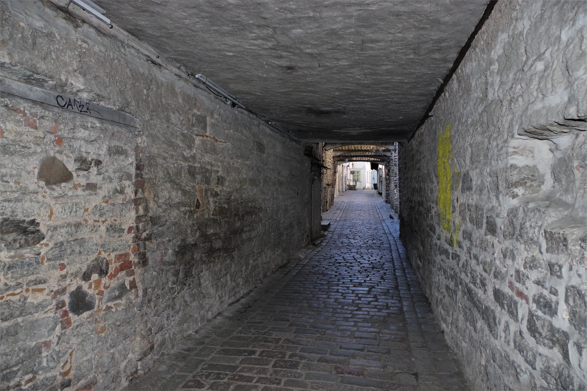 St Catherine's Passage (Katariina käik), a narrow cobbled medieval covered lane between old stone walls in Tallinn Old Town