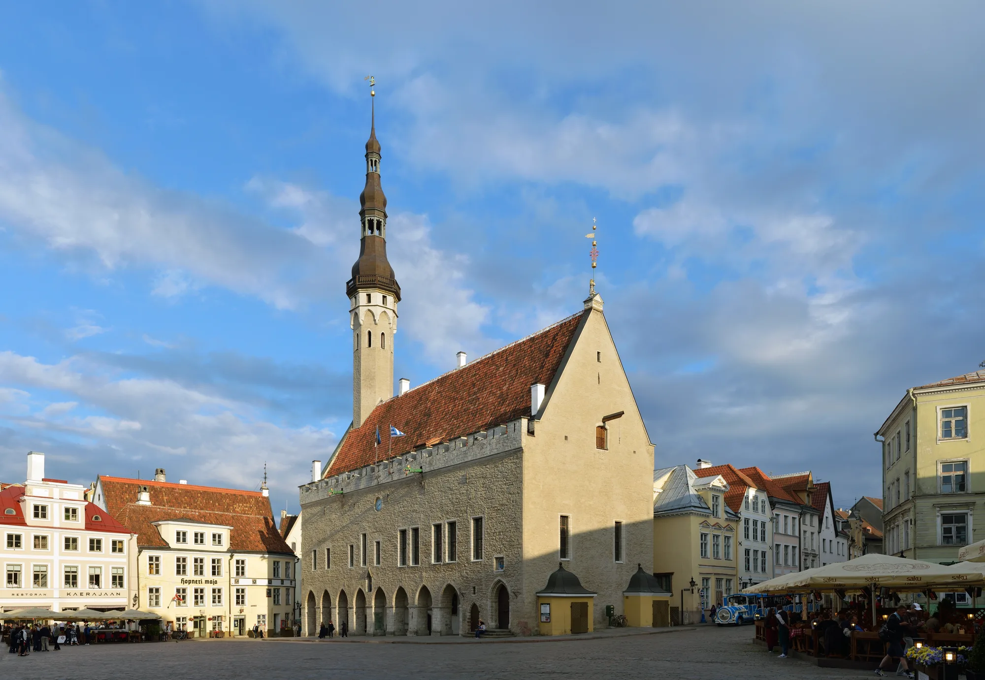 Tallinn's Town Hall Square (Raekoja plats) with the Gothic Town Hall and its tall spire over the cobbled medieval square in summer