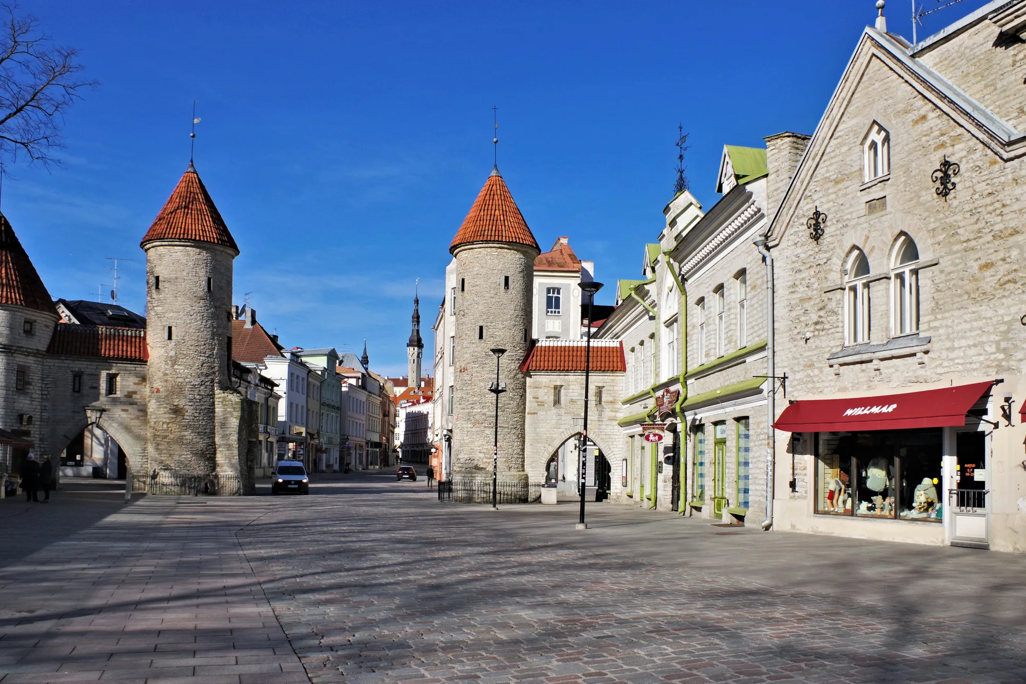 The two round medieval Viru Gate towers with conical red roofs at the eastern entrance to Tallinn Old Town